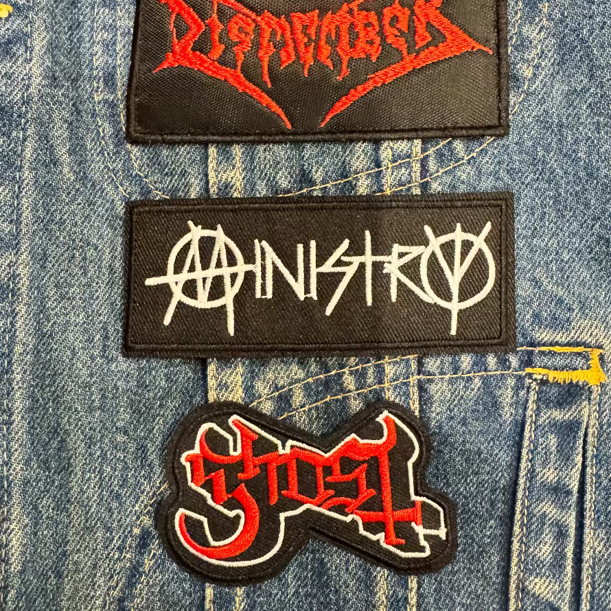 Ministry embroidered patch on denim battle jacket with metal patches. 