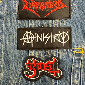 Ministry embroidered patch on denim battle jacket with metal patches. 